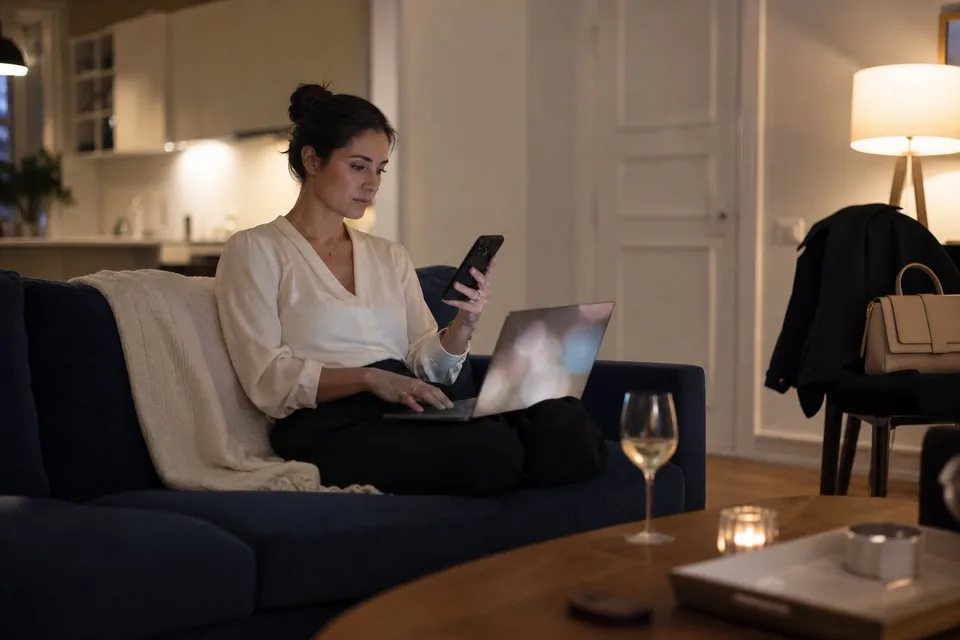 Woman checking a match's details on a laptop before a first date