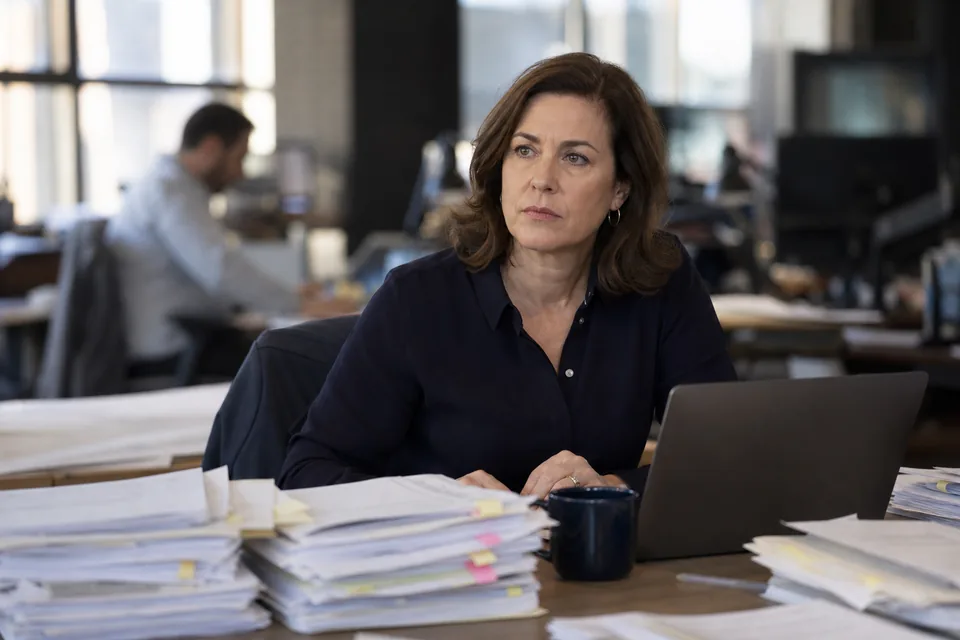 Reporter reviewing court records on a newsroom desk